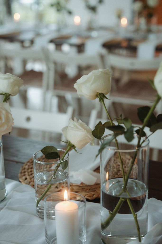 Kerzenschein und weiße Rosen bei abendlicher Hochzeitsdeko in Neuss